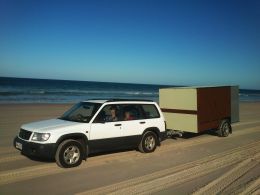 Forester and camper on beach